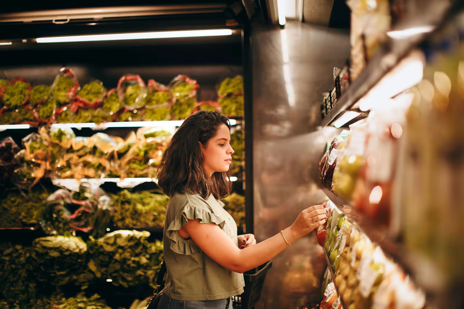 Woman choosing fresh produce in a grocery store