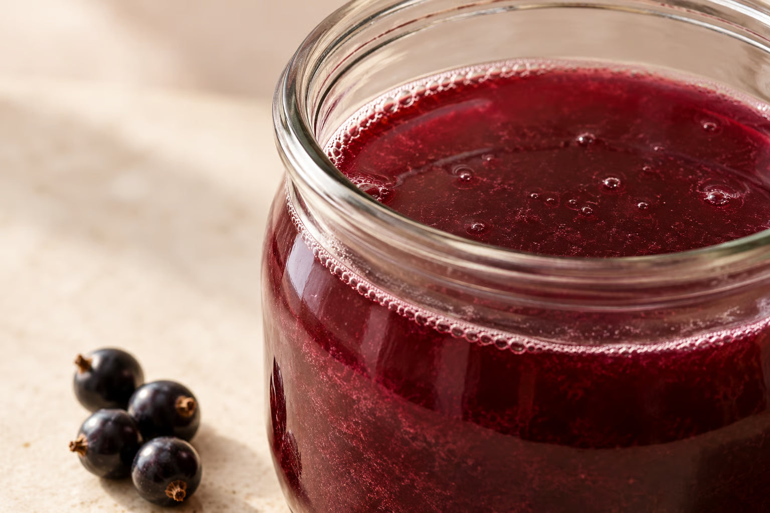 Close-up of a glass jar with fermented berry drink